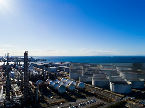 Coastal refinery and product storage tanks beside the sea