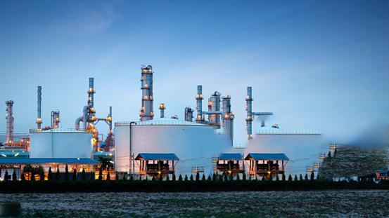 Oil refinery at dusk with storage tanks