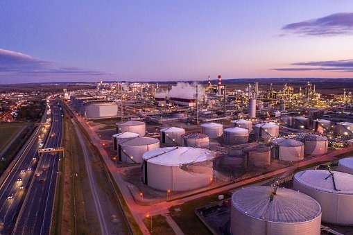 Petroleum storage tank farm and refinery at dusk