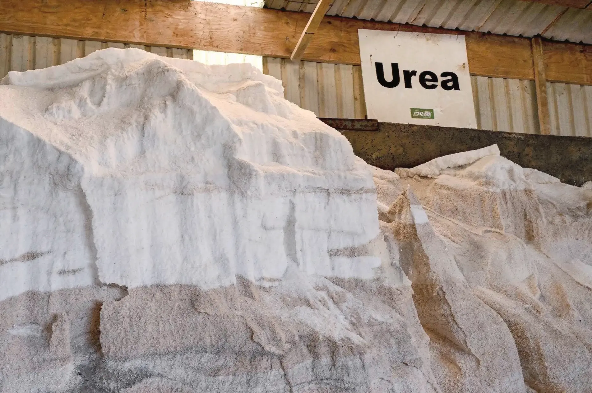 Bulk urea stockpile stored under cover at a fertilizer warehouse